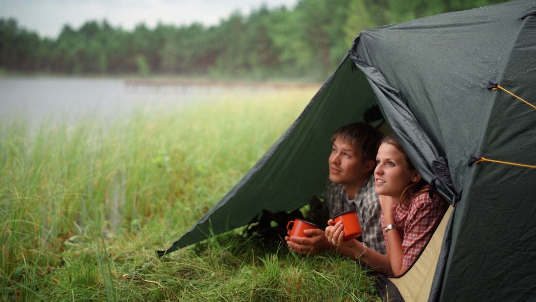 Young Couple in Tent by Lake